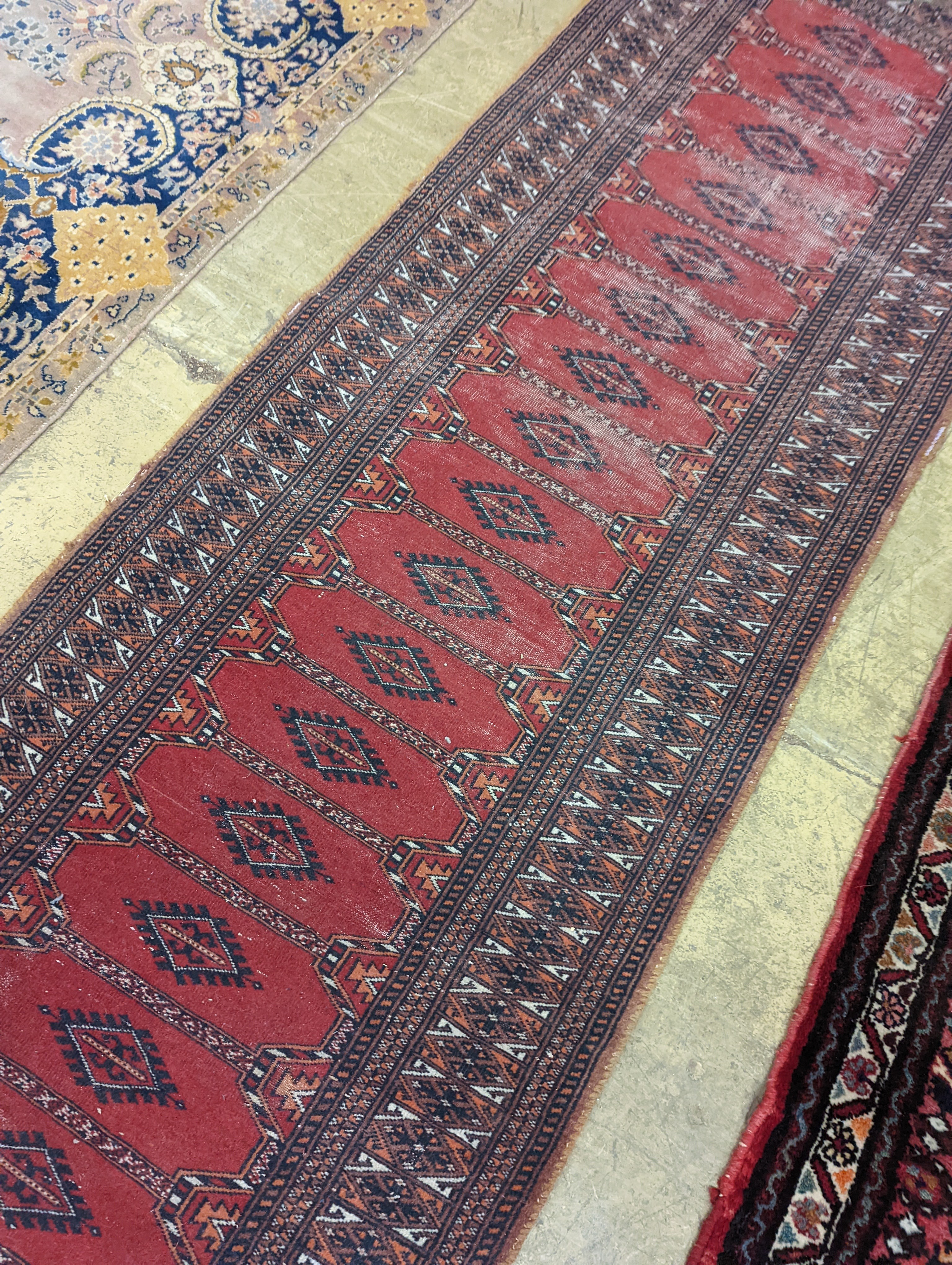 A North West Persian red ground runner and a Bokhara runner, larger approx. 290 x 78cm